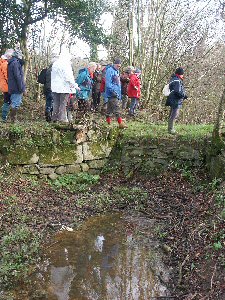 Walkers at filled-in bridge hole