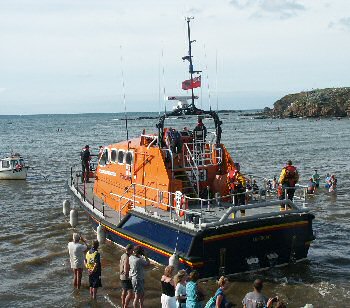 Visiting lifeboat leaving the sea lock